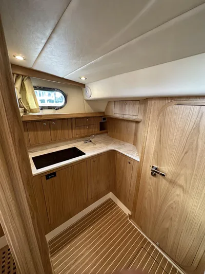 Fratelli Aprea Sorrento 32 Yacht Photos Pics 2023 Fratelli Aprea Sorrento Cabinatto 32 interior kitchen area with wooden cabinetry.