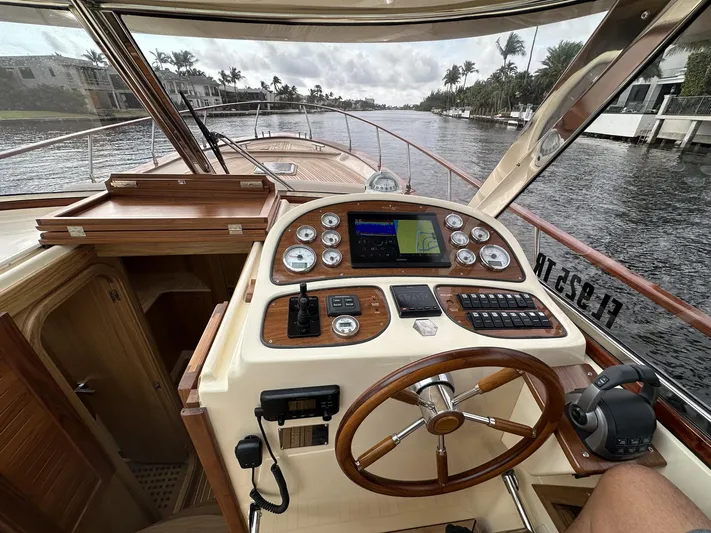 Fratelli Aprea Sorrento 32 Yacht Photos Pics Fratelli Aprea Sorrento Cabinatto 32, 2023 model, boat cockpit with navigation controls on a waterway.