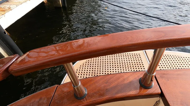 Fratelli Aprea Sorrento 32 Yacht Photos Pics Fratelli Aprea Sorrento Cabinatto 32, 2023 model, wooden deck and railing detail by the water.