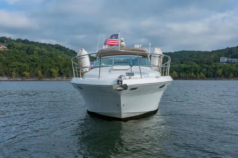 Just The Two Of Us Yacht Photos Pics 1997 Sea Ray 400 Sundancer yacht on a lake with forested shoreline.