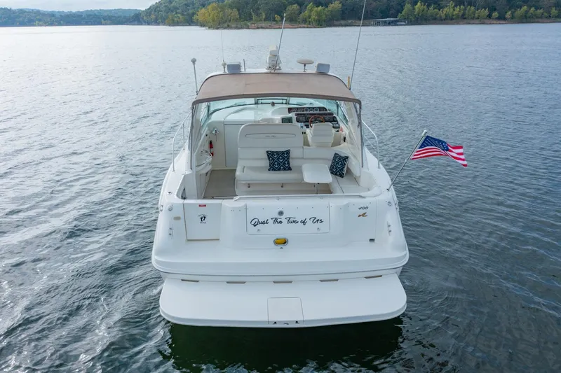 Just The Two Of Us Yacht Photos Pics 1997 Sea Ray 400 Sundancer yacht on calm water, rear view with American flag.