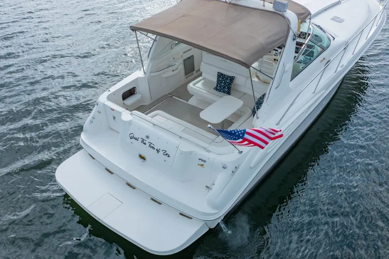 Just The Two Of Us Yacht Photos Pics 1997 Sea Ray 400 Sundancer yacht on water, American flag, spacious deck.