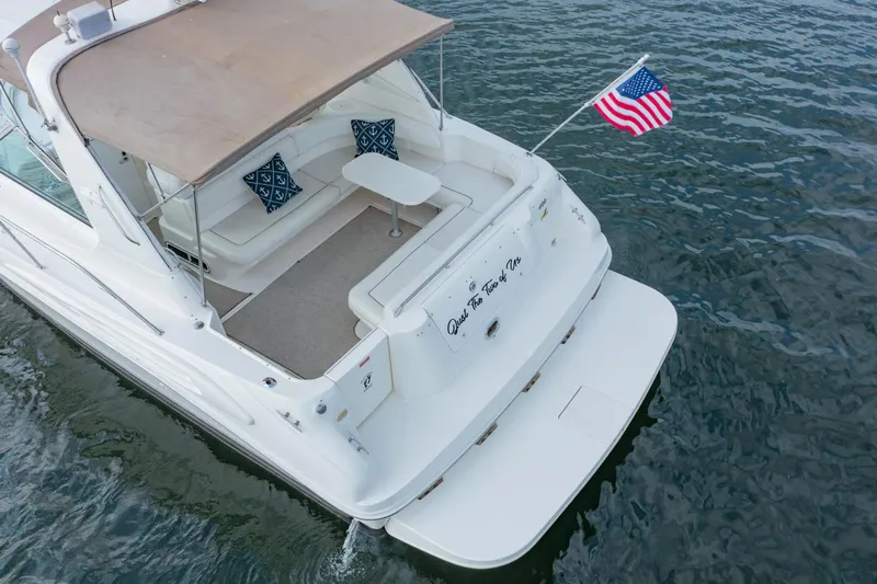 Just The Two Of Us Yacht Photos Pics 1997 Sea Ray 400 Sundancer yacht with American flag on calm water.