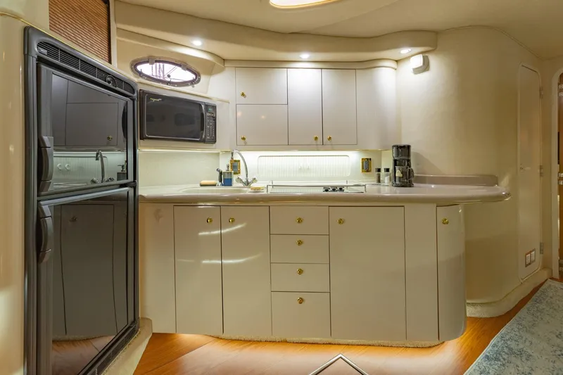 Just The Two Of Us Yacht Photos Pics Luxurious 1997 Sea Ray 400 Sundancer yacht kitchen with modern appliances and elegant cabinetry.