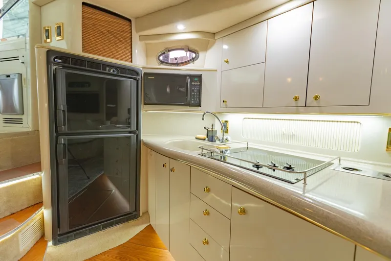 Just The Two Of Us Yacht Photos Pics Luxurious 1997 Sea Ray 400 Sundancer yacht kitchen with modern appliances and sleek cabinetry.