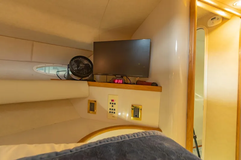 Just The Two Of Us Yacht Photos Pics 1997 Sea Ray 400 Sundancer cabin interior with TV, fan, and control panel.