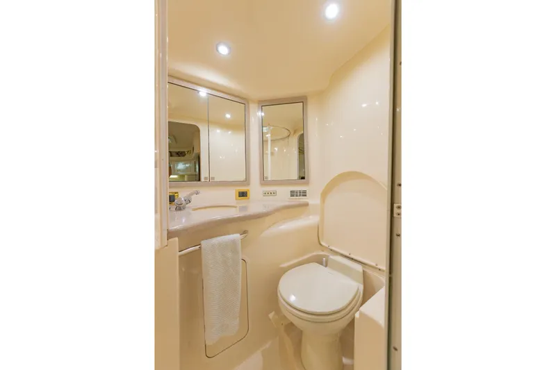 Just The Two Of Us Yacht Photos Pics Bathroom interior of 1997 Sea Ray 400 Sundancer yacht, featuring a toilet and mirrored cabinets.