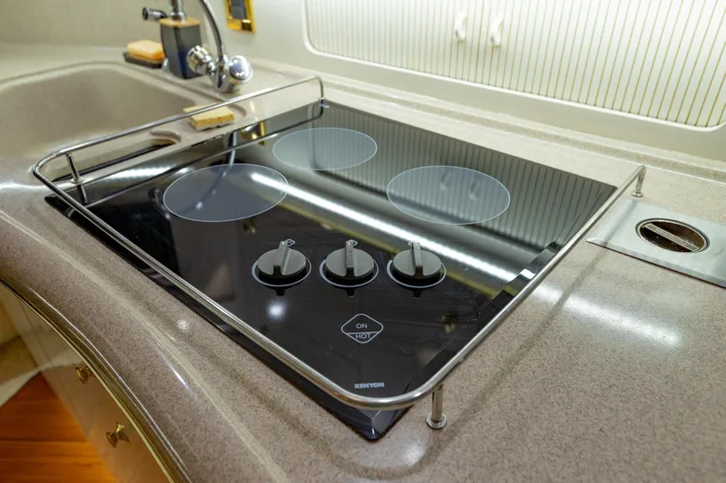 Just The Two Of Us Yacht Photos Pics Stovetop in 1997 Sea Ray 400 Sundancer yacht kitchen, featuring sleek design and modern controls.