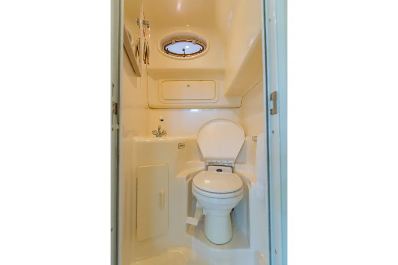 Just The Two Of Us Yacht Photos Pics 1997 Sea Ray 400 Sundancer bathroom with compact toilet and sink.