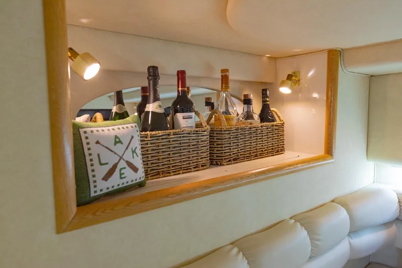 Just The Two Of Us Yacht Photos Pics Luxurious 1997 Sea Ray 400 Sundancer interior with wine bottles and cozy decor.