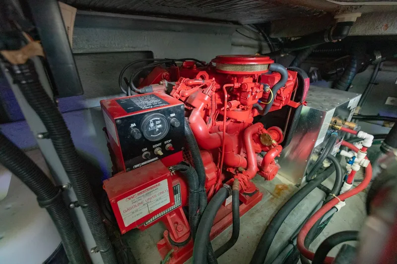 Just The Two Of Us Yacht Photos Pics Engine room of a 1997 Sea Ray 400 Sundancer with red machinery and wiring.