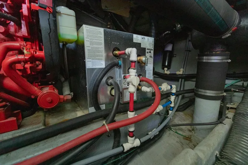 Just The Two Of Us Yacht Photos Pics Engine room of a 1997 Sea Ray 400 Sundancer with visible piping and machinery.