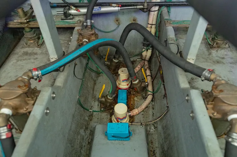 Just The Two Of Us Yacht Photos Pics Engine compartment of a 1997 Sea Ray 400 Sundancer with visible hoses and fittings.