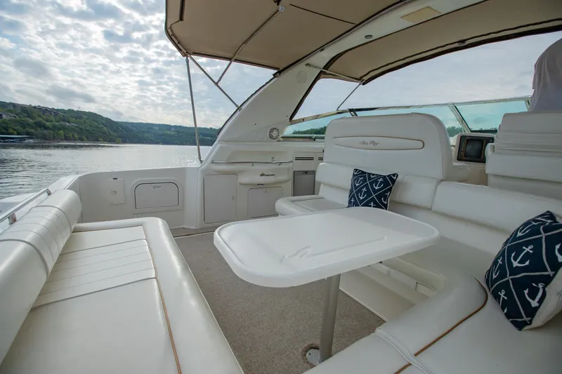Just The Two Of Us Yacht Photos Pics 1997 Sea Ray 400 Sundancer yacht interior with white seating, table, and nautical pillows.