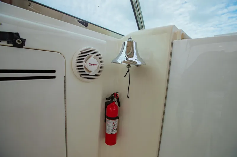 Just The Two Of Us Yacht Photos Pics 1997 Sea Ray 400 Sundancer interior with bell, speaker, and fire extinguisher.