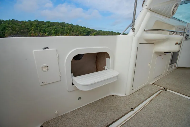 Just The Two Of Us Yacht Photos Pics 1997 Sea Ray 400 Sundancer interior with storage compartment and fresh water access.