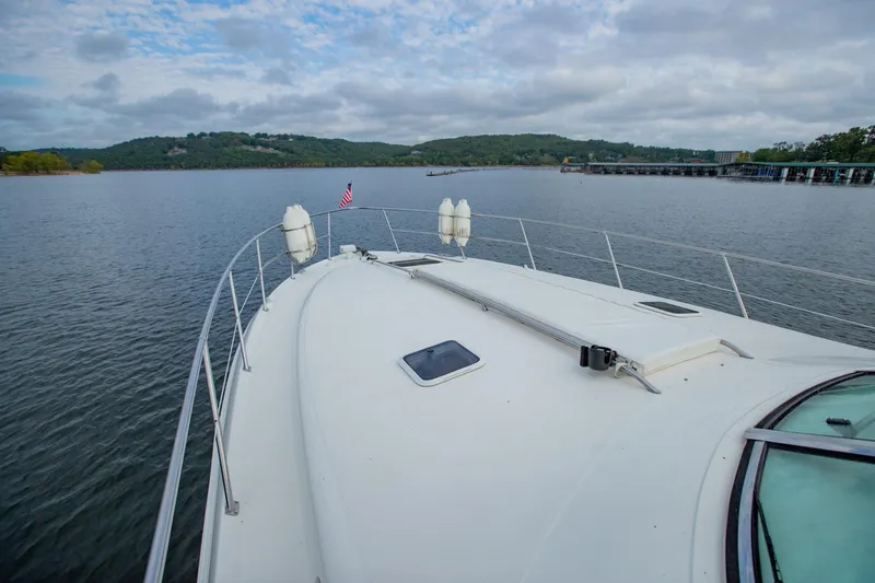Just The Two Of Us Yacht Photos Pics 1997 Sea Ray 400 Sundancer yacht on a serene lake with scenic hills.