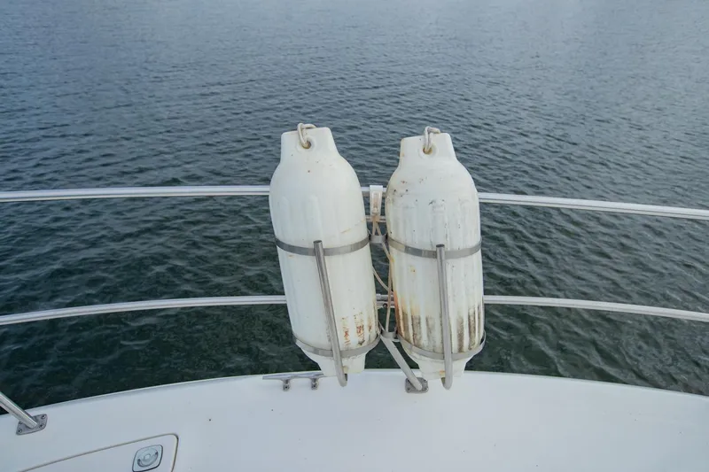 Just The Two Of Us Yacht Photos Pics White fenders on 1997 Sea Ray 400 Sundancer boat against water backdrop.