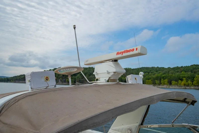 Just The Two Of Us Yacht Photos Pics 1997 Sea Ray 400 Sundancer boat with radar equipment, cruising on a scenic lake.