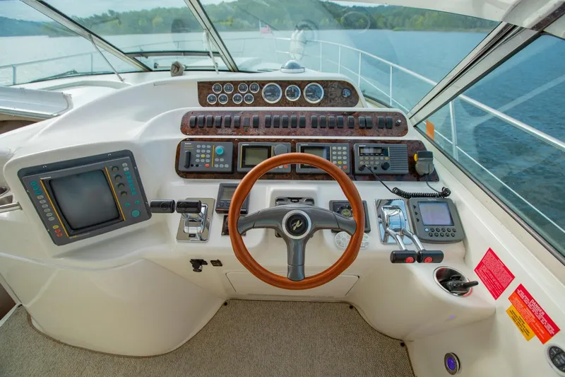 Just The Two Of Us Yacht Photos Pics Cockpit of 1997 Sea Ray 400 Sundancer with steering wheel and navigation controls.