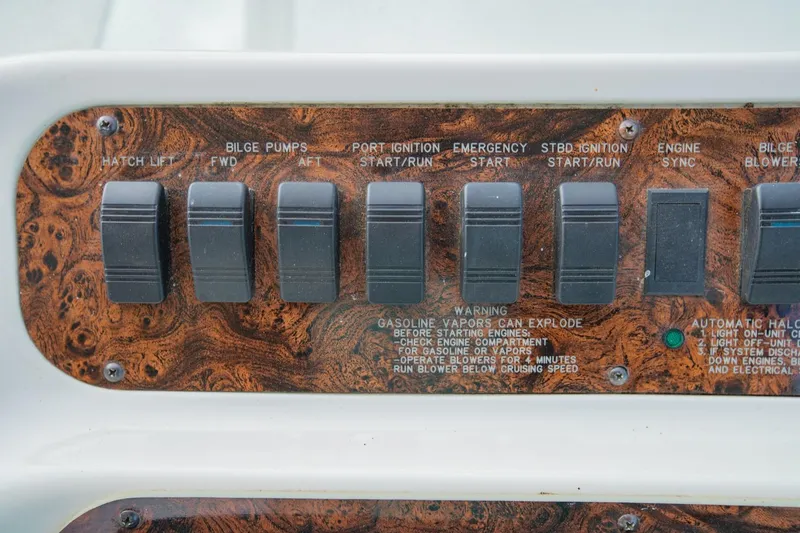 Just The Two Of Us Yacht Photos Pics Control panel of a 1997 Sea Ray 400 Sundancer boat with various switches.