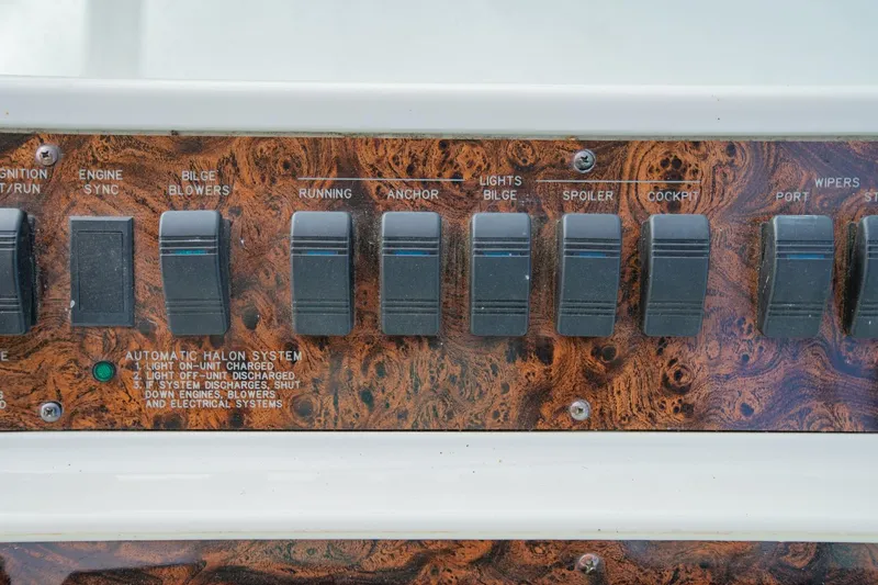 Just The Two Of Us Yacht Photos Pics Control panel of a 1997 Sea Ray 400 Sundancer boat with various switches.