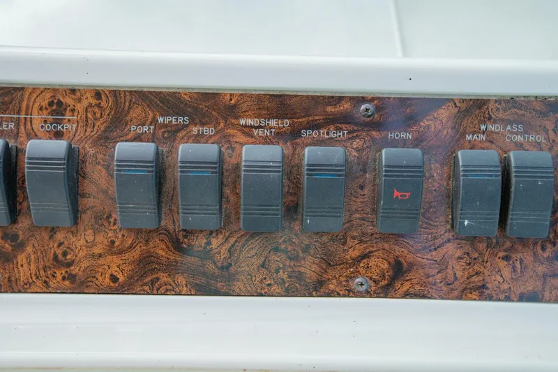 Just The Two Of Us Yacht Photos Pics Control panel of a 1997 Sea Ray 400 Sundancer boat with various switches.