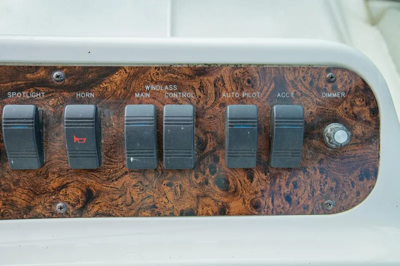 Just The Two Of Us Yacht Photos Pics Control panel of a 1997 Sea Ray 400 Sundancer boat with various switches.