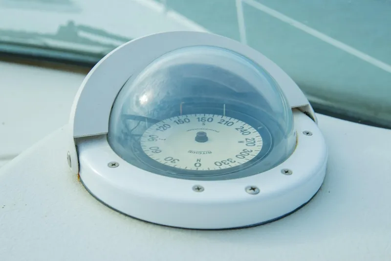 Just The Two Of Us Yacht Photos Pics Compass on 1997 Sea Ray 400 Sundancer boat dashboard, under clear dome.