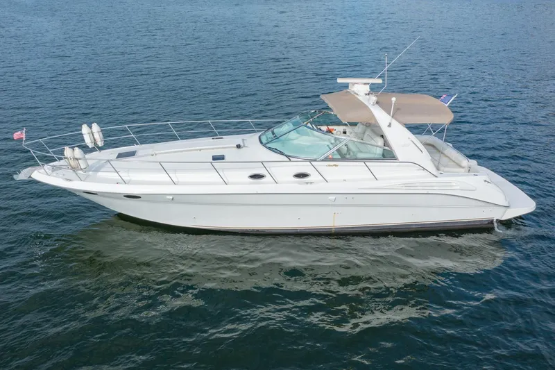 Just The Two Of Us Yacht Photos Pics 1997 Sea Ray 400 Sundancer yacht cruising on open water.