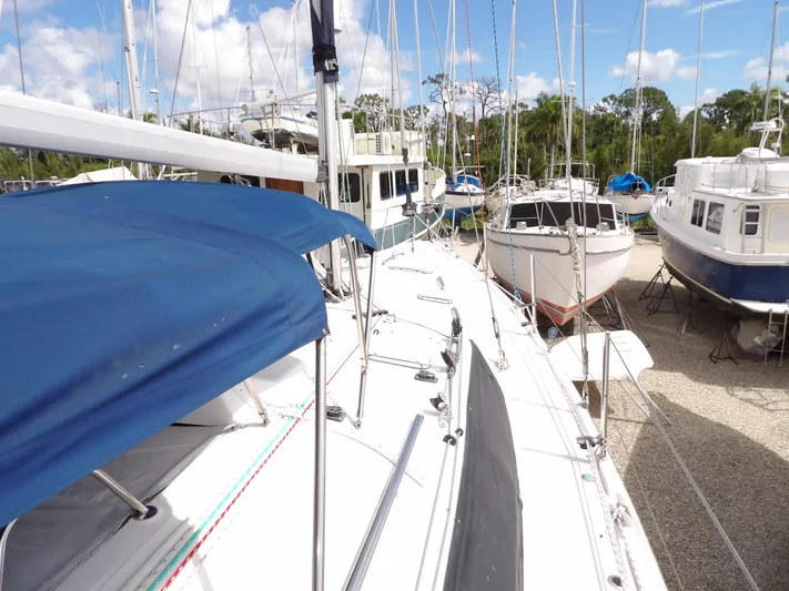 Summer Breeze Yacht Photos Pics Hunter 460 sailboat, 2000 model, docked among other boats under a clear sky.
