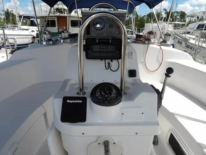 Summer Breeze Yacht Photos Pics Hunter 460 sailboat cockpit with navigation equipment, compass, and steering wheel, year 2000 model.