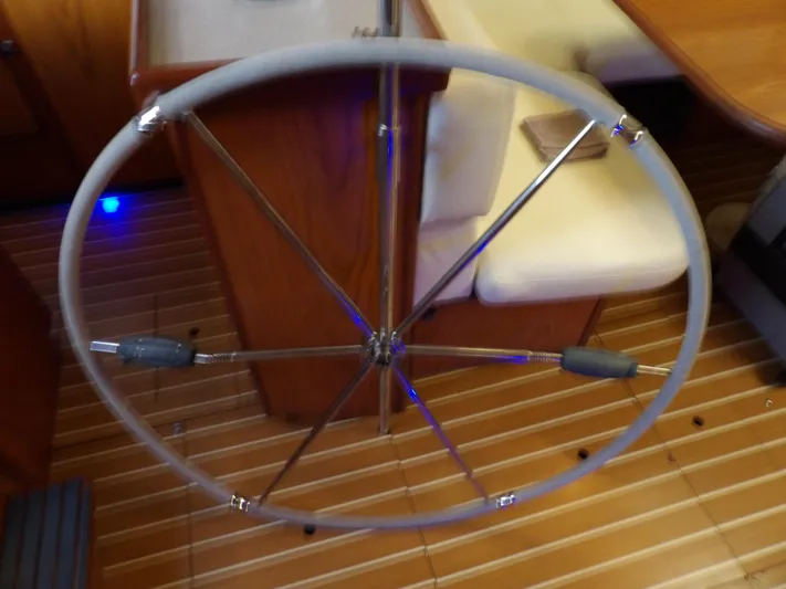 Summer Breeze Yacht Photos Pics Steering wheel of a 2000 Hunter 460 sailboat, wooden interior.
