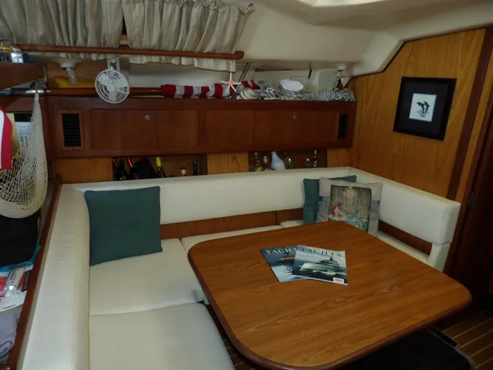 Summer Breeze Yacht Photos Pics Interior of 2000 Hunter 460 sailboat with cozy dining area and wooden table.