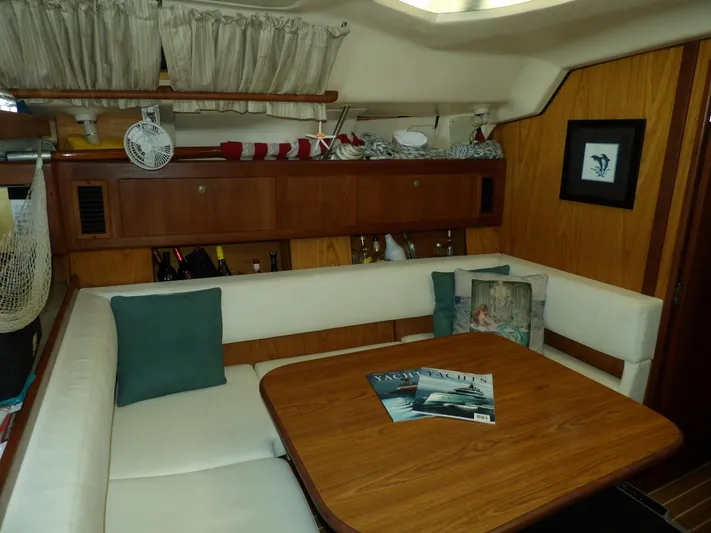 Summer Breeze Yacht Photos Pics Interior of 2000 Hunter 460 sailboat with dining area and wooden table.