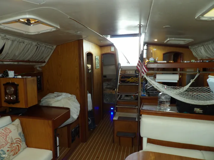 Summer Breeze Yacht Photos Pics Interior of a 2000 Hunter 460 sailboat with wooden furnishings and cozy seating.