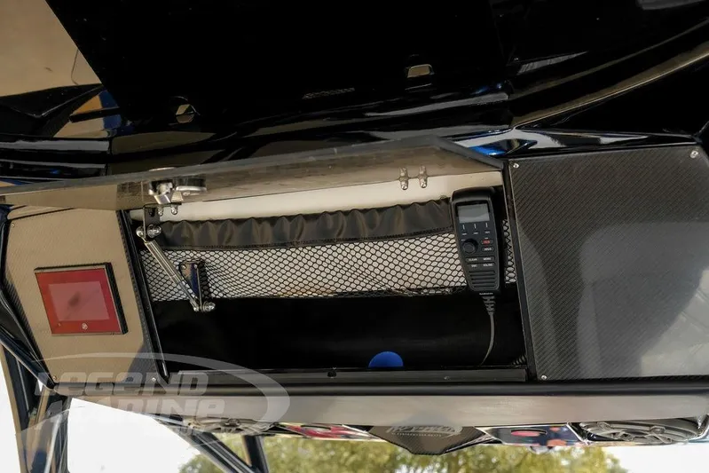  Yacht Photos Pics 2023 Nor-Tech 390 Sport Center Console storage compartment with radio and netting.