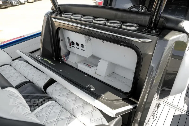  Yacht Photos Pics 2023 Nor-Tech 390 Sport Center Console interior with open storage compartment and luxurious seating.