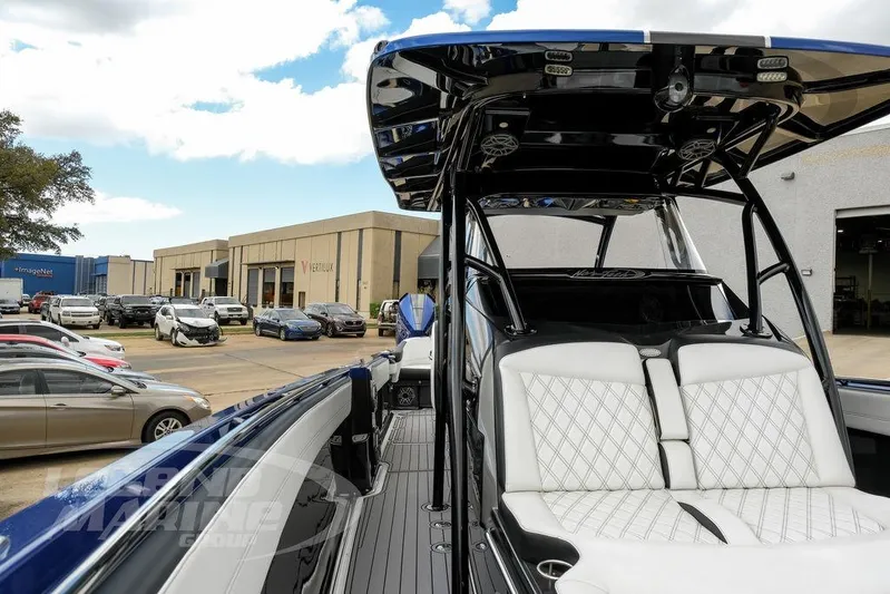  Yacht Photos Pics 2023 Nor-Tech 390 Sport Center Console boat with sleek design in a parking lot setting.