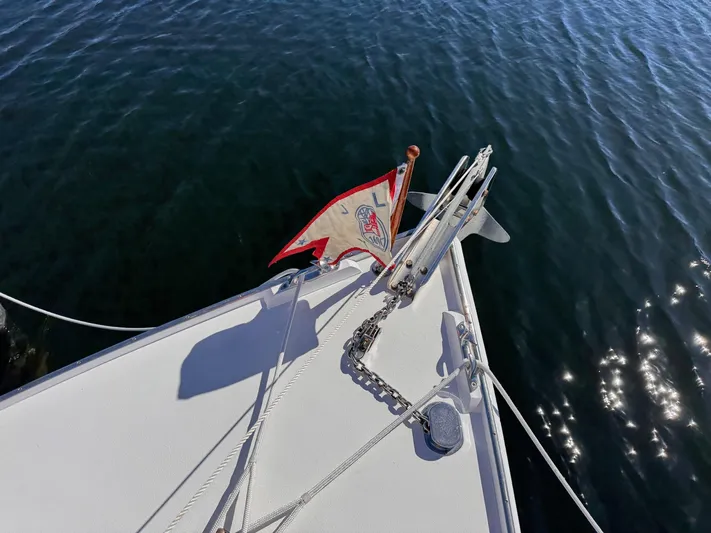 Grey Dawn Yacht Photos Pics Bow of 1987 West Bay James Beal 31 Lobster Boat with flag and anchor chain.
