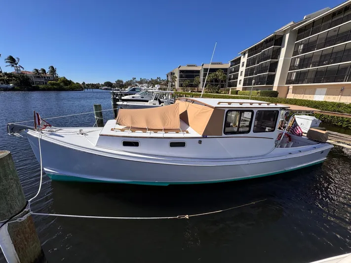 Grey Dawn Yacht Photos Pics 1987 West Bay James Beal 31 Hardtop Lobster Boat docked in a sunny marina.
