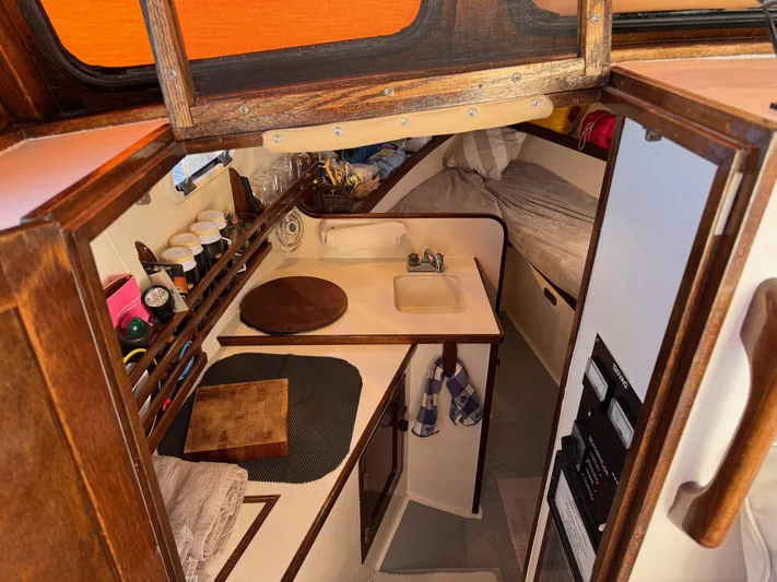 Grey Dawn Yacht Photos Pics Interior of 1987 West Bay James Beal 31 Hardtop Lobster Boat, featuring cozy cabin and kitchenette.