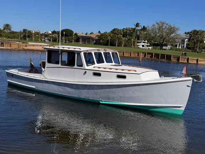 Grey Dawn Yacht Photos Pics 1987 West Bay James Beal 31 Hardtop Lobster Boat on calm water, scenic background.