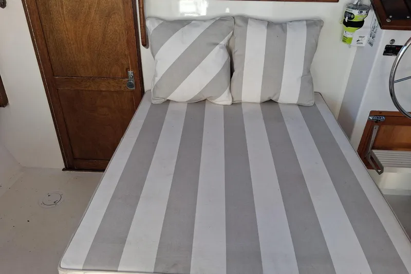 Grey Dawn Yacht Photos Pics Interior of 1987 West Bay James Beal 31 Lobster Boat with striped cushions.