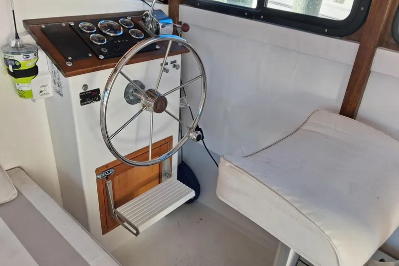 Grey Dawn Yacht Photos Pics 1987 West Bay James Beal 31 Hardtop Lobster Boat helm with steering wheel and gauges.