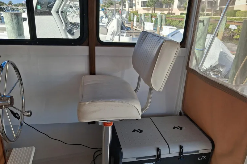 Grey Dawn Yacht Photos Pics 1987 West Bay James Beal 31 Hardtop Lobster Boat interior with steering wheel and seat.
