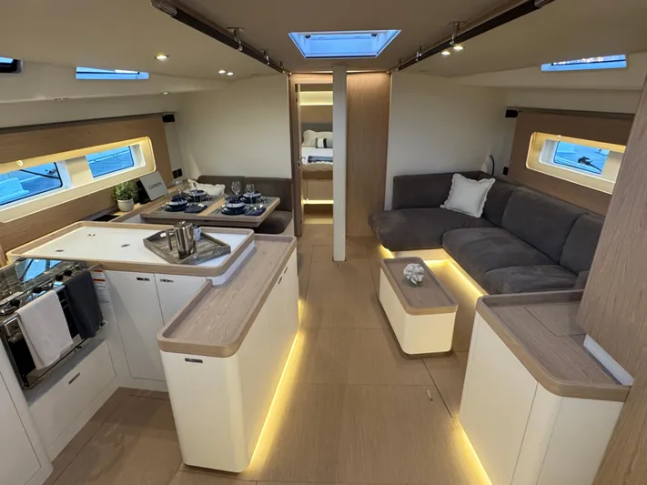  Yacht Photos Pics Luxurious interior of 2023 Beneteau First 53 yacht with modern kitchen and seating area.