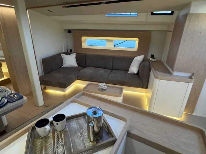  Yacht Photos Pics Luxurious interior of 2023 Beneteau First 53 yacht with modern seating and elegant decor.