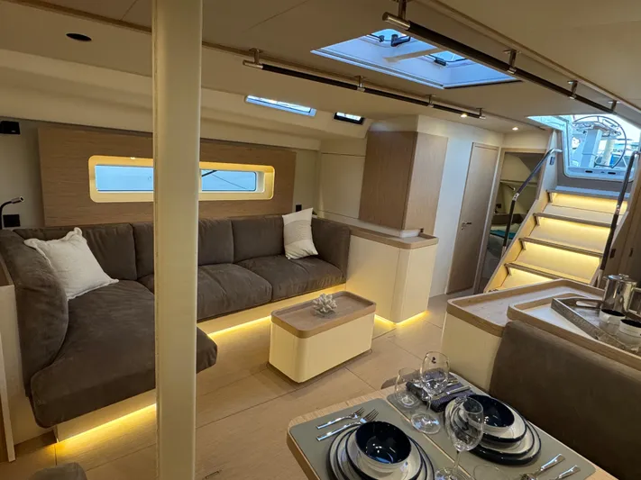  Yacht Photos Pics Luxurious interior of 2023 Beneteau First 53 yacht with modern furnishings and ambient lighting.