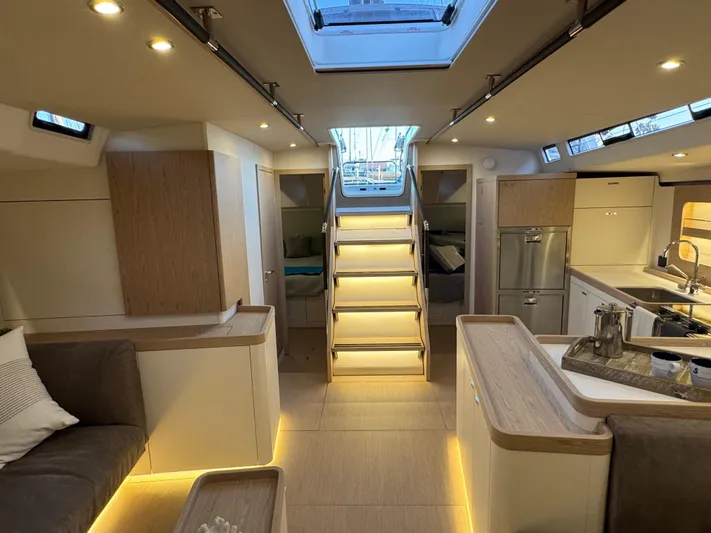  Yacht Photos Pics Luxurious interior of 2023 Beneteau First 53 yacht, featuring modern design and ambient lighting.